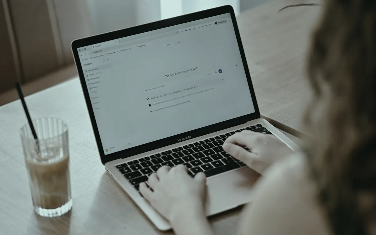 Person typing into an assistant on a laptop