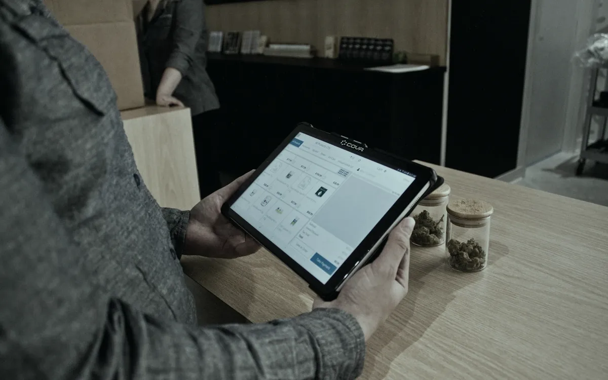 Shop owner managing inventory on a tablet