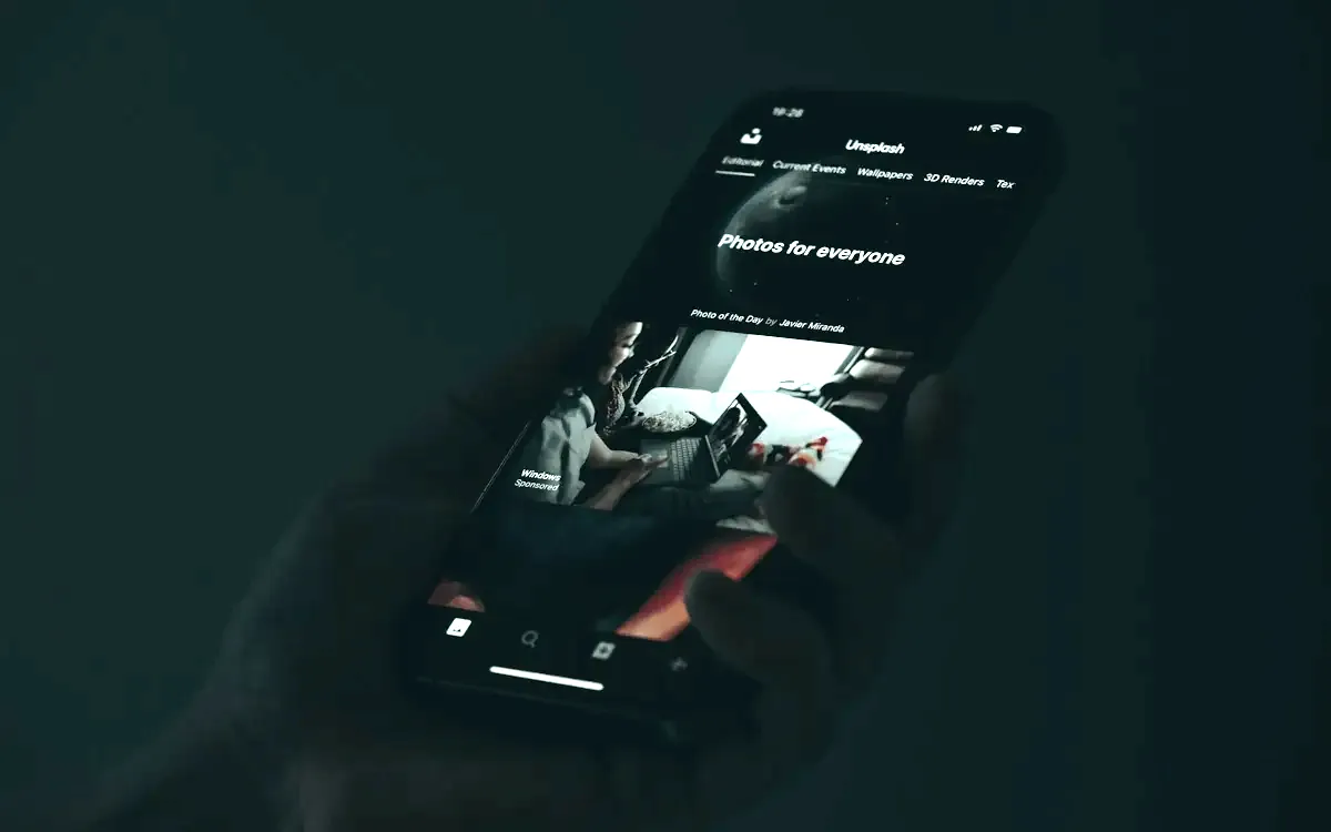 Hand holding a smartphone with an app open